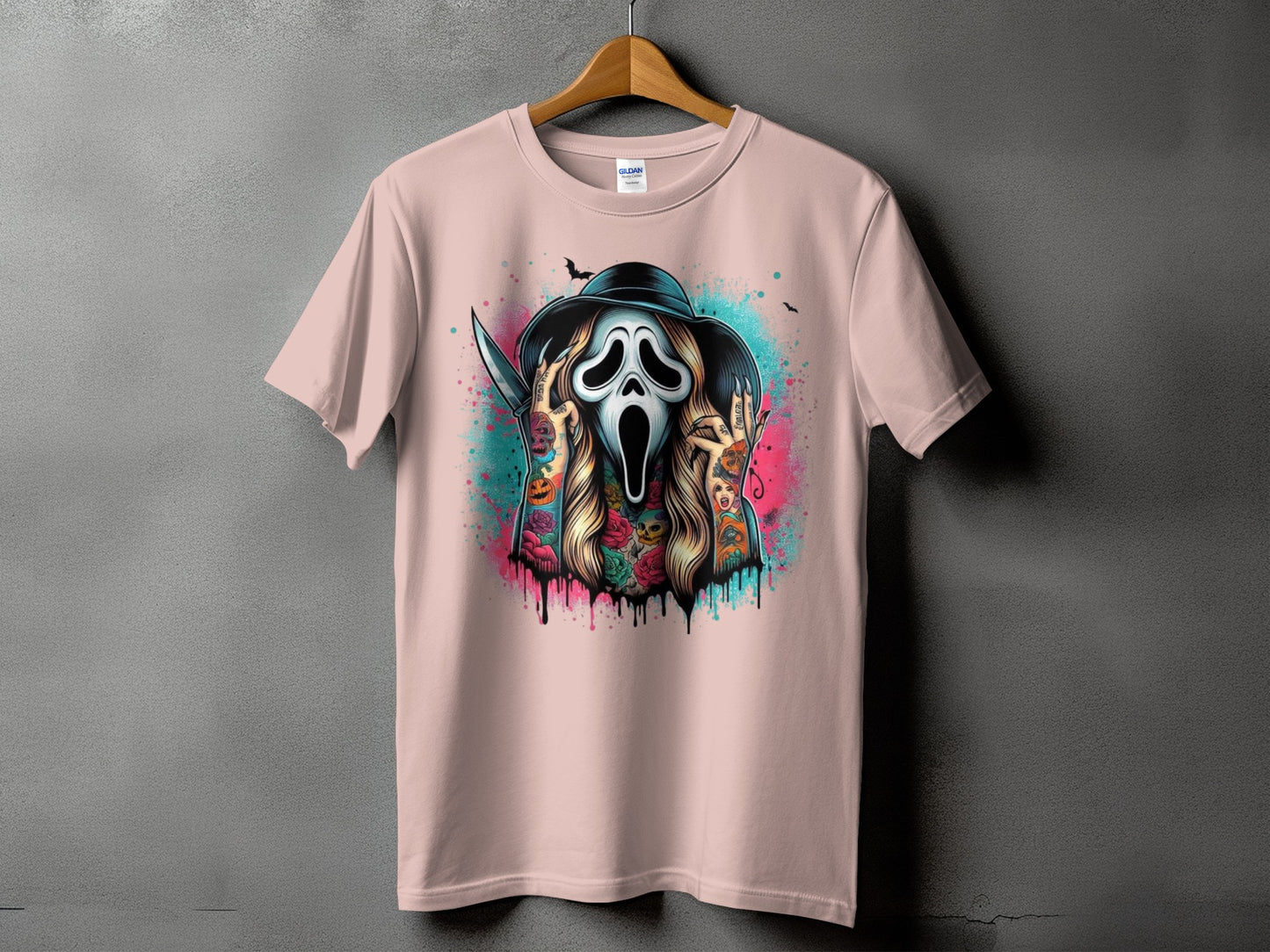 Pink t-shirt with a tattoo-style Scream mask, knife, and Halloween imagery.