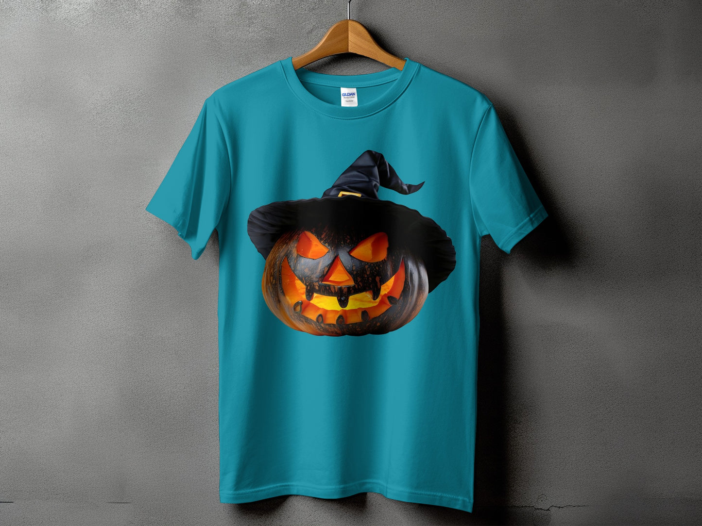 Teal t-shirt with a spooky jack-o'-lantern wearing a witch's hat graphic.