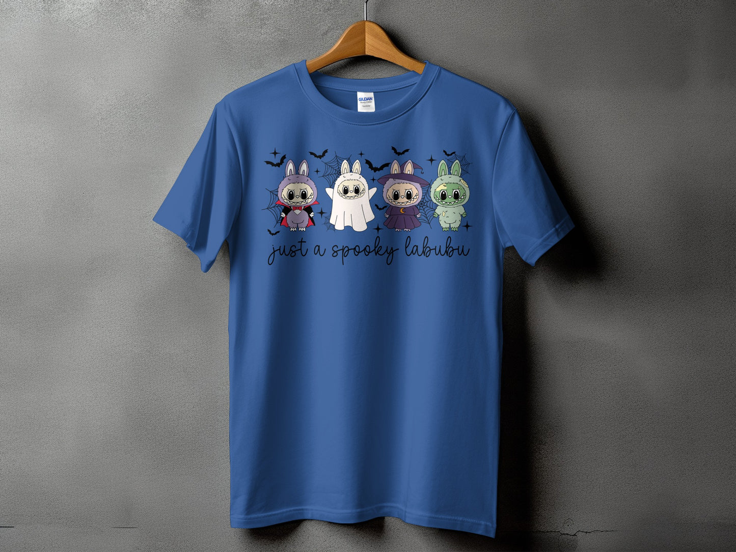 Blue t-shirt with four cute Halloween-themed labubu characters and text.