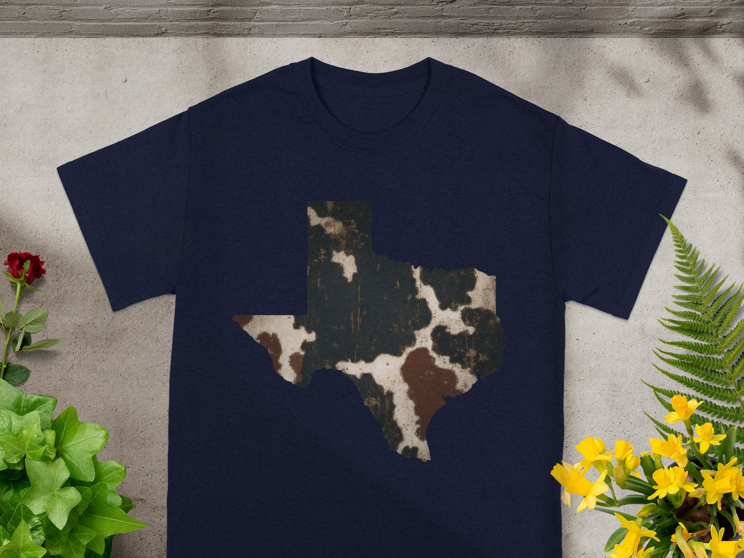 Navy t-shirt with distressed cowhide-patterned Texas outline graphic.