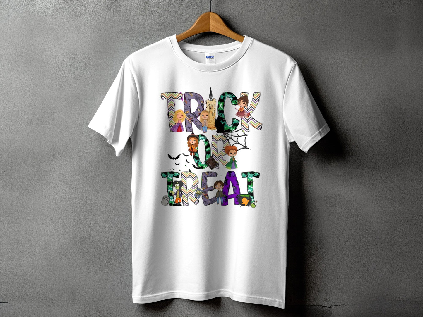 White t-shirt with "Trick or Treat" Halloween graphic featuring cartoon witches and spooky elements.