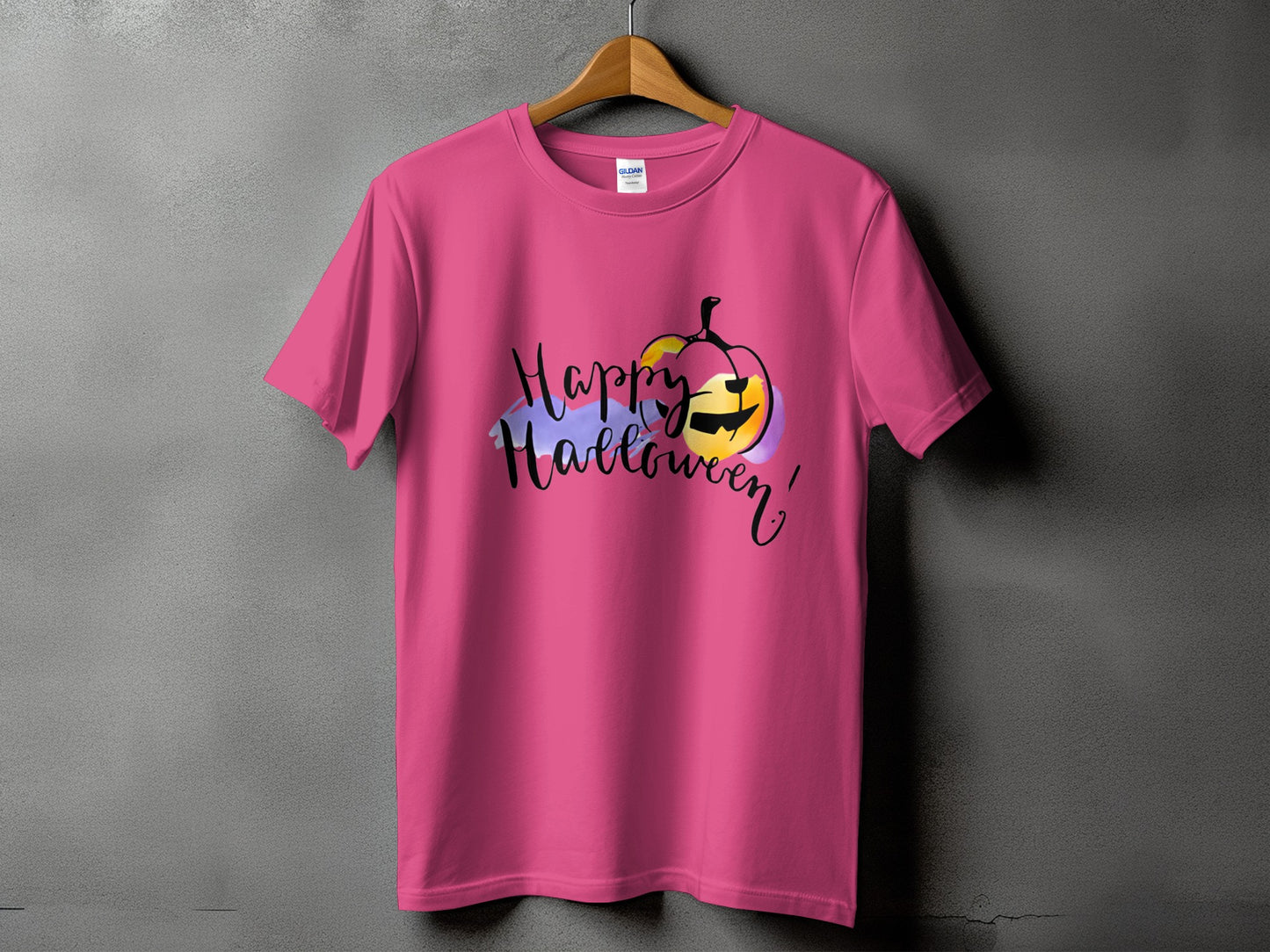 Pink t-shirt with a black Halloween graphic featuring a pumpkin and the words "Happy Halloween!".