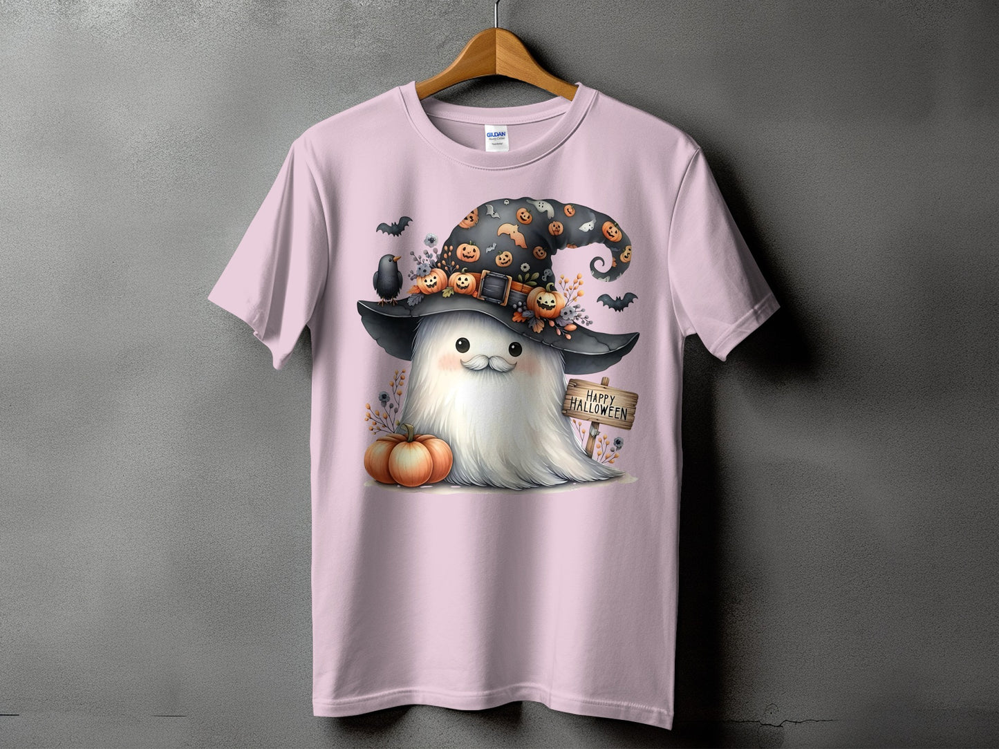 Pink t-shirt with a ghost wearing a witch hat with pumpkins and bats.