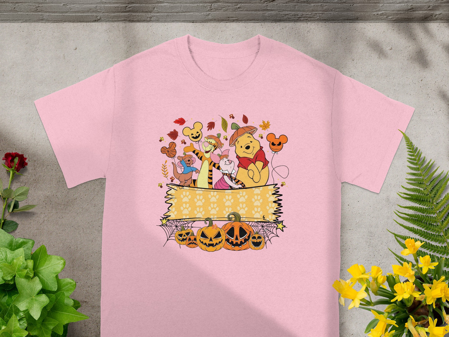 Winnie the Pooh and friends in a Halloween scene with pumpkins and autumn leaves.
