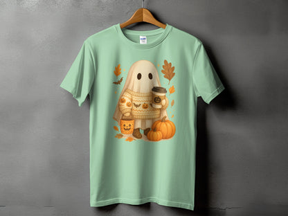Mint green t-shirt with a cartoon ghost holding a coffee cup and surrounded by pumpkins and leaves.