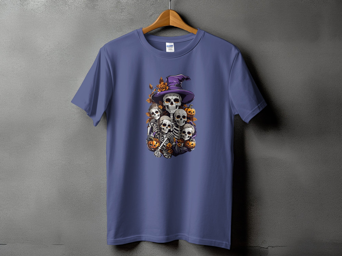 Purple t-shirt with a Halloween graphic of skeletons, pumpkins, and a witch hat.