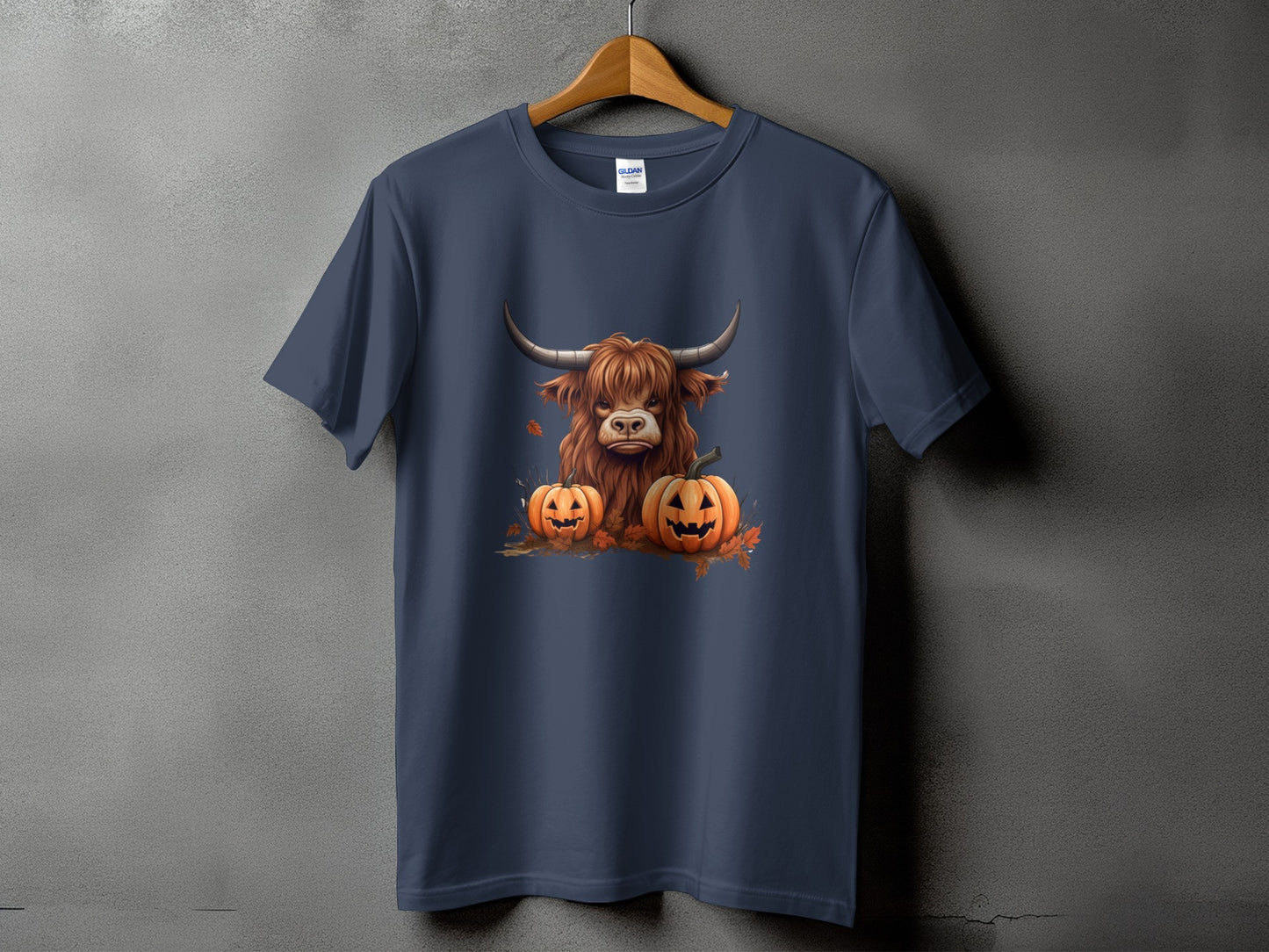 Dark blue t-shirt with a Highland cow and two jack-o'-lanterns graphic.