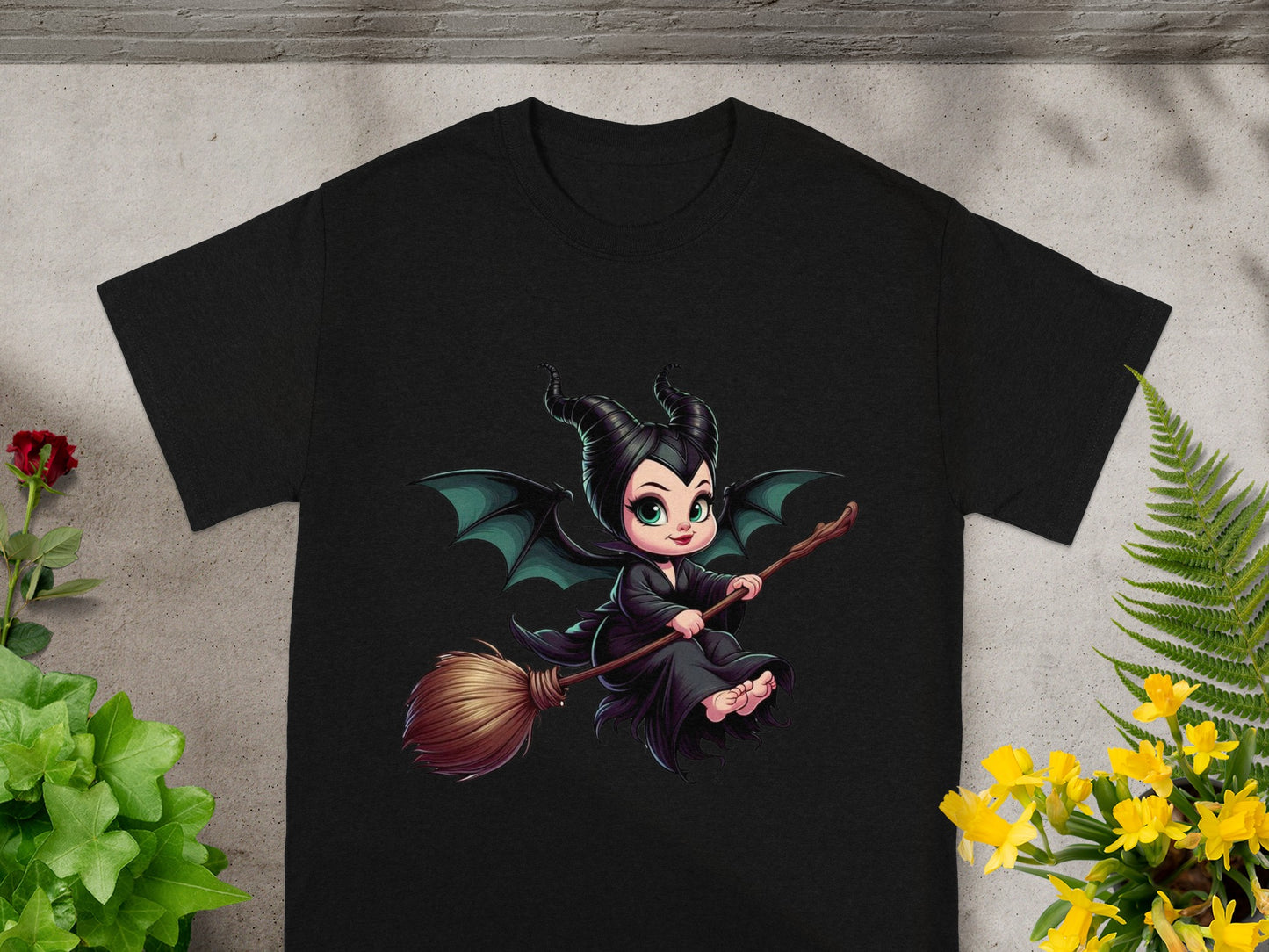 Black t-shirt with a cartoon Maleficent flying on a broomstick.