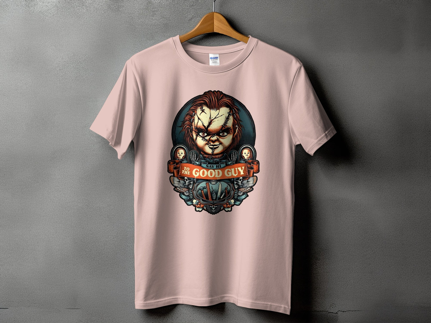 Pink t-shirt with Chucky graphic and "Say Hi to the Good Guy" text.