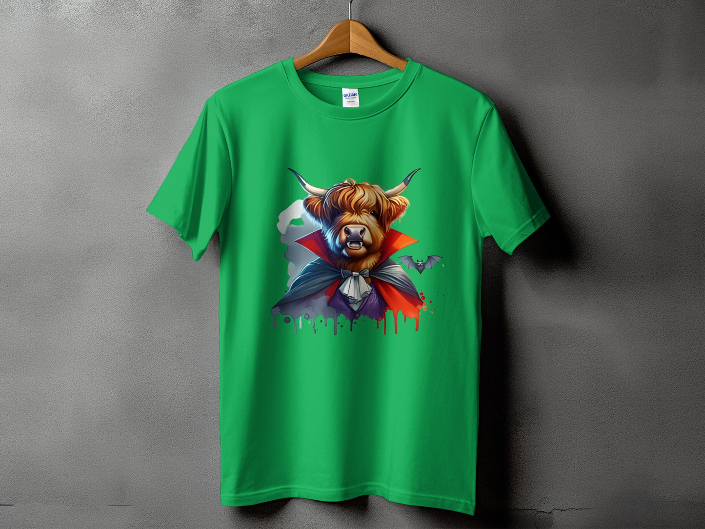 Highland cow dressed as a vampire with bats on a green t-shirt.