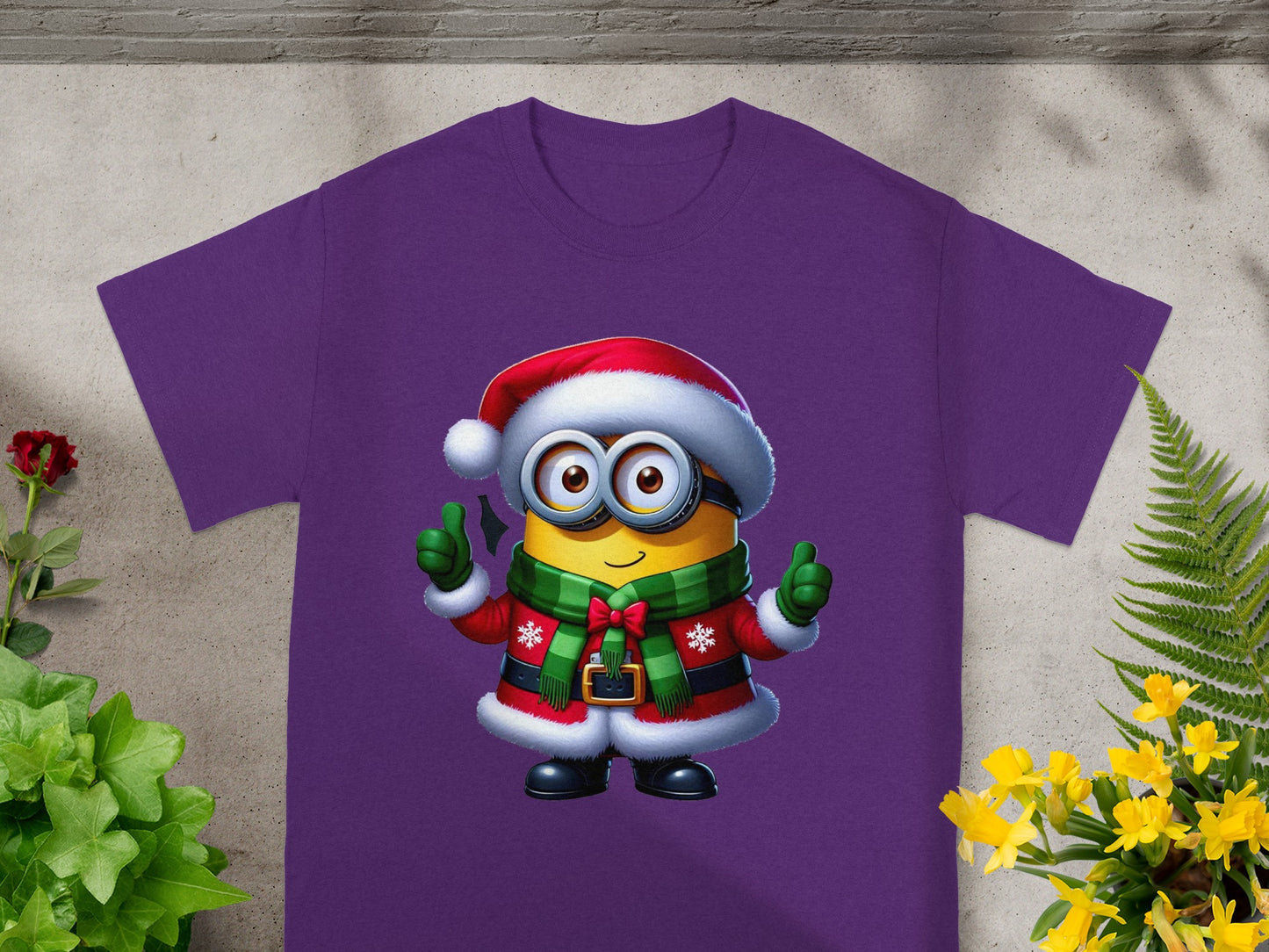 Purple t-shirt featuring a Minion character in a Santa hat and holiday outfit.