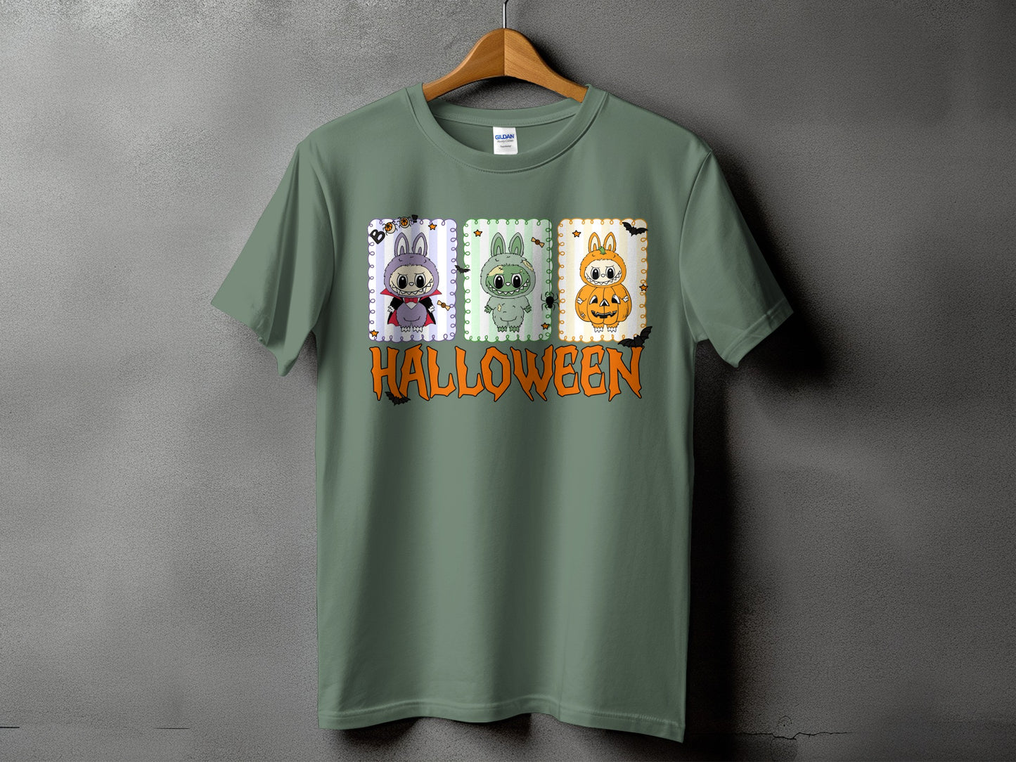 Green t-shirt with three Halloween-themed bunny illustrations and the word "HALLOWEEN" below.