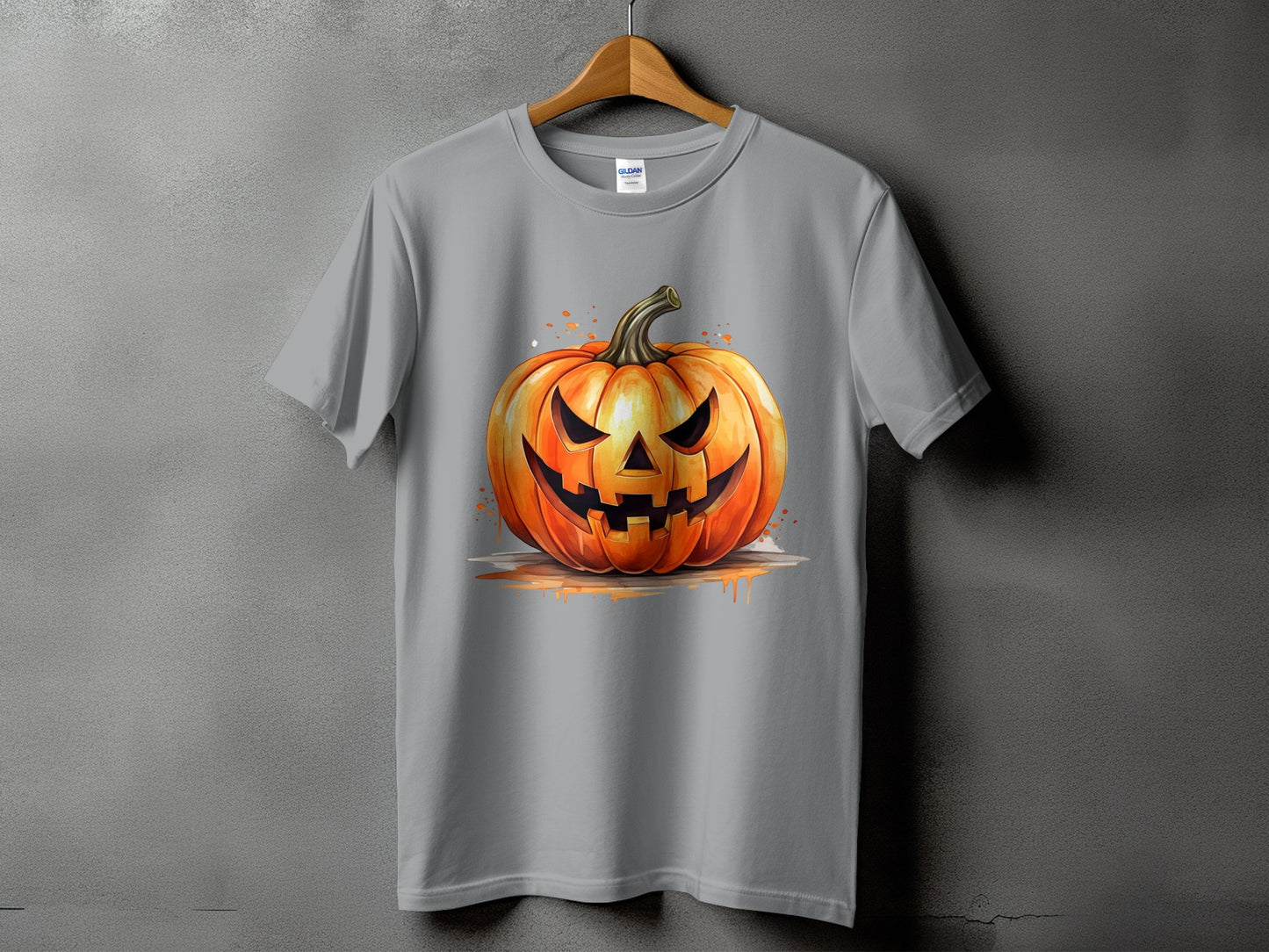 Gray t-shirt with a watercolor illustration of a carved Halloween jack-o'-lantern.
