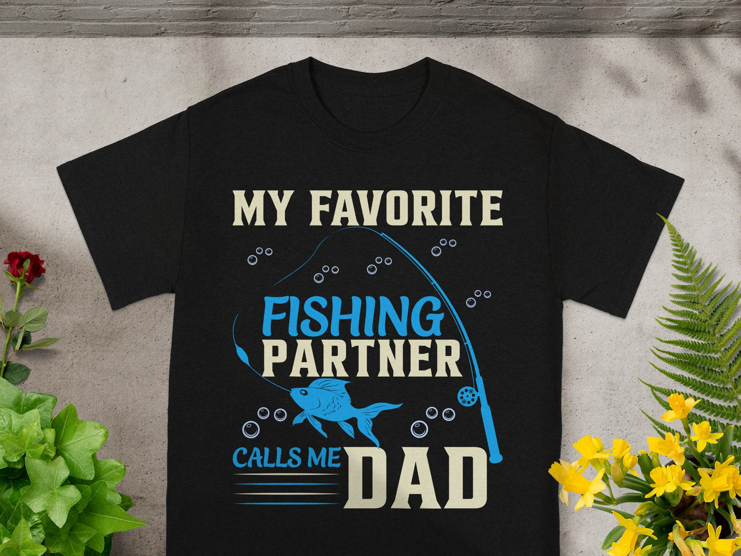 Black t-shirt with fishing graphic and text "My Favorite Fishing Partner Calls Me Dad".