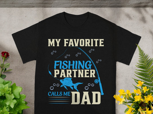 Black t-shirt with fishing graphic and text "My Favorite Fishing Partner Calls Me Dad".