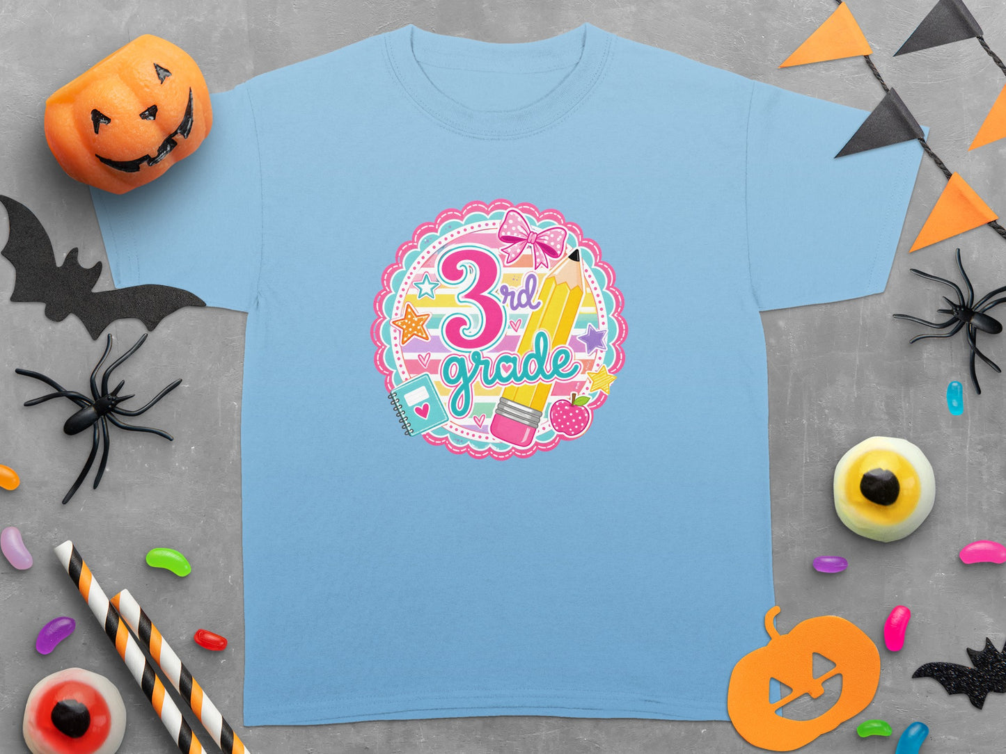 Light blue t-shirt with "3rd grade" graphic featuring pencil, bow, and school supplies.