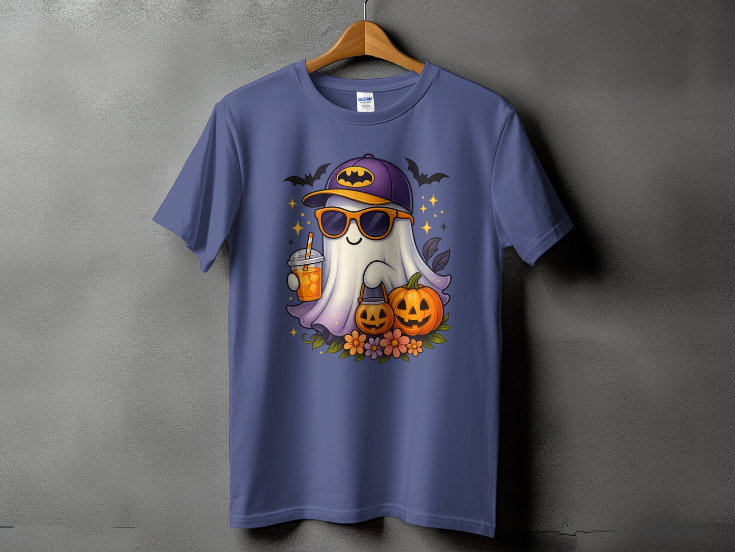 Ghost in sunglasses and cap with drink, pumpkins, flowers, and bats design on a t-shirt.