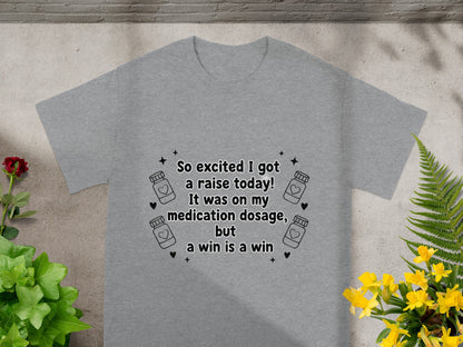 Gray t-shirt with text "So excited I got a raise today! It was on my medication dosage, but a win is a win."