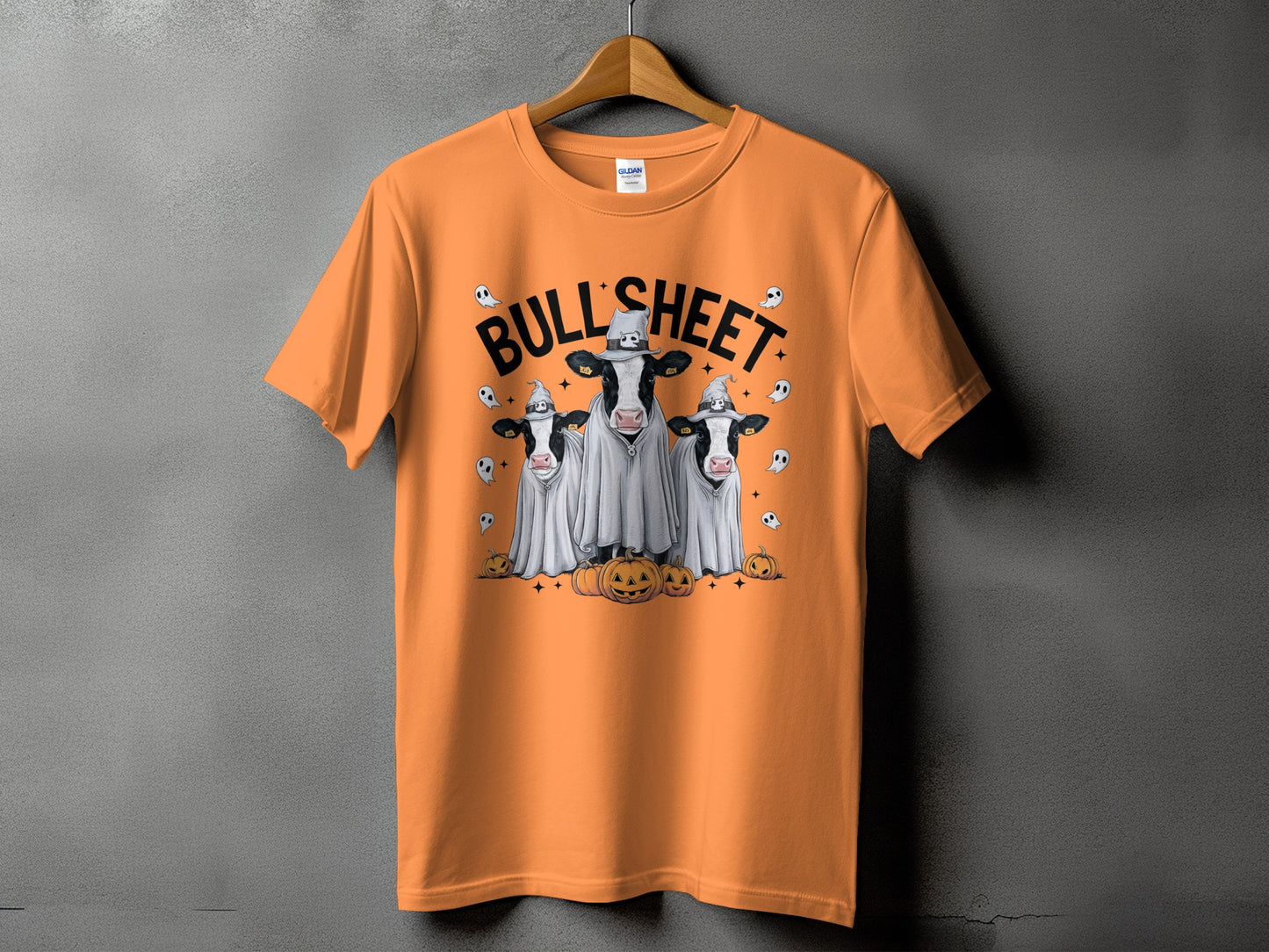 Orange t-shirt with ghost-covered cows, pumpkins, and the text "BULL SHEET."