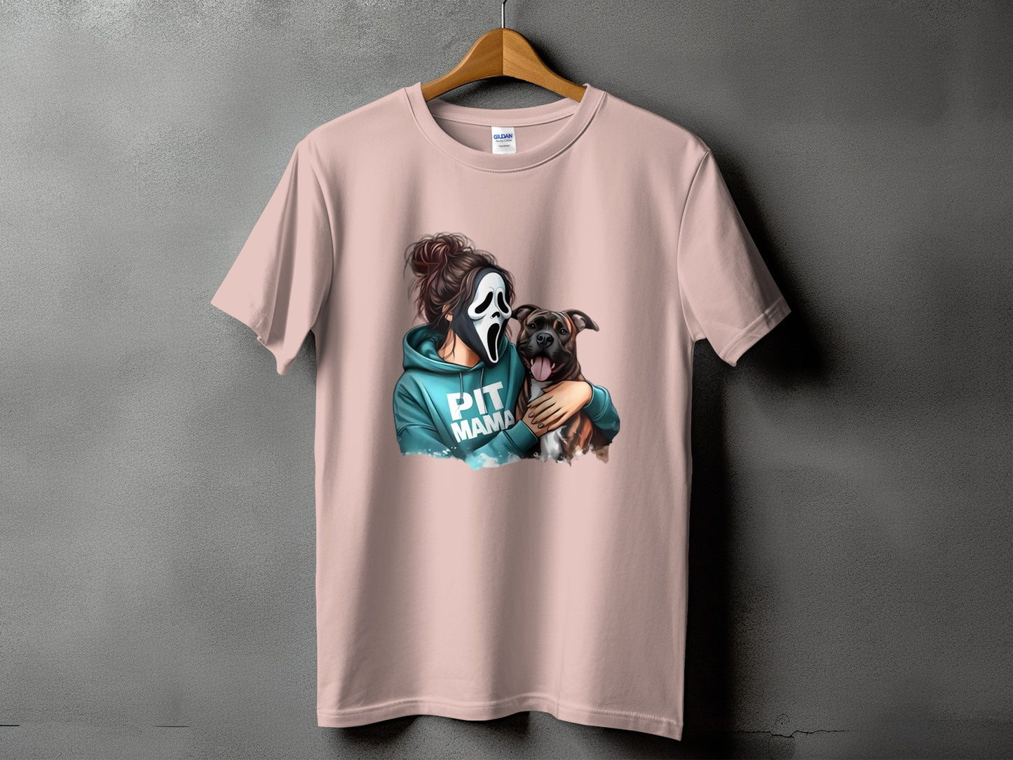 Pink t-shirt with a graphic of a person wearing a scream mask holding a pit bull and the text "PIT MAMA".