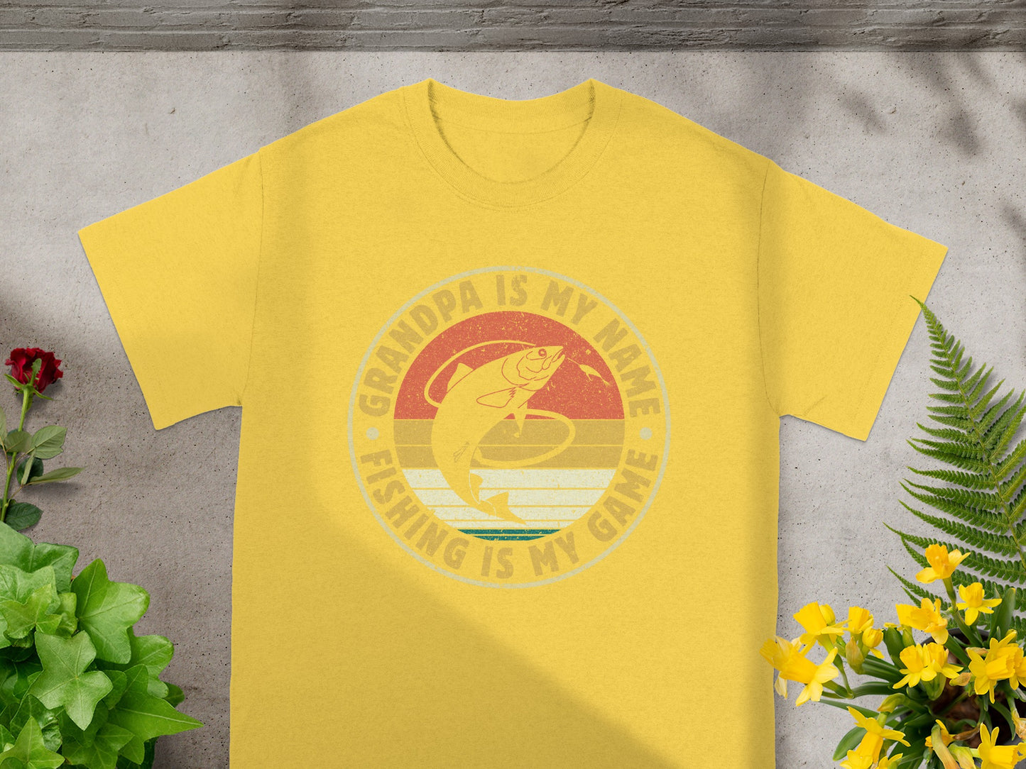 Yellow t-shirt with circular vintage fishing graphic that says "Grandpa is my name. Fishing is my game."