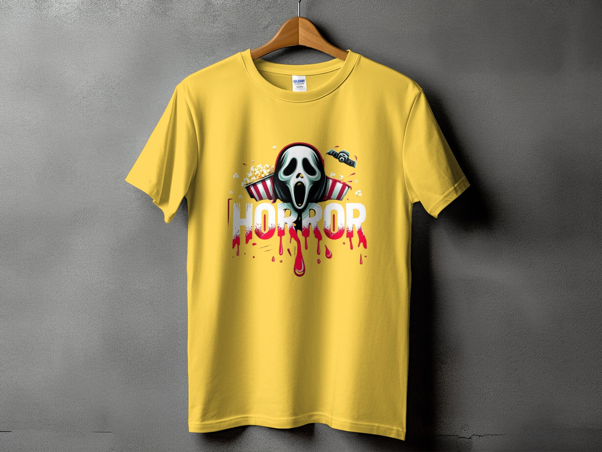 Yellow t-shirt with horror graphic featuring a screaming mask, popcorn, and dripping blood.