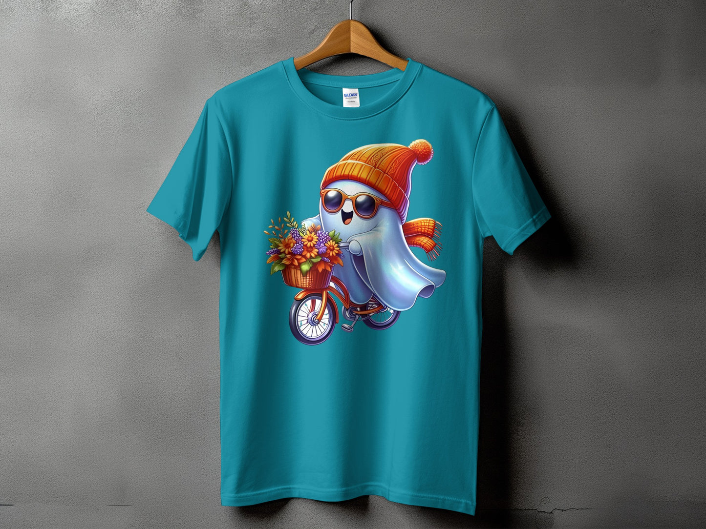 Teal t-shirt with graphic of a cartoon ghost riding a bicycle with flowers.