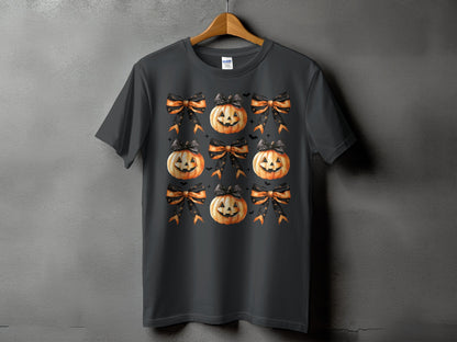 Dark grey t-shirt with a repeating pattern of jack-o'-lanterns and Halloween bows.
