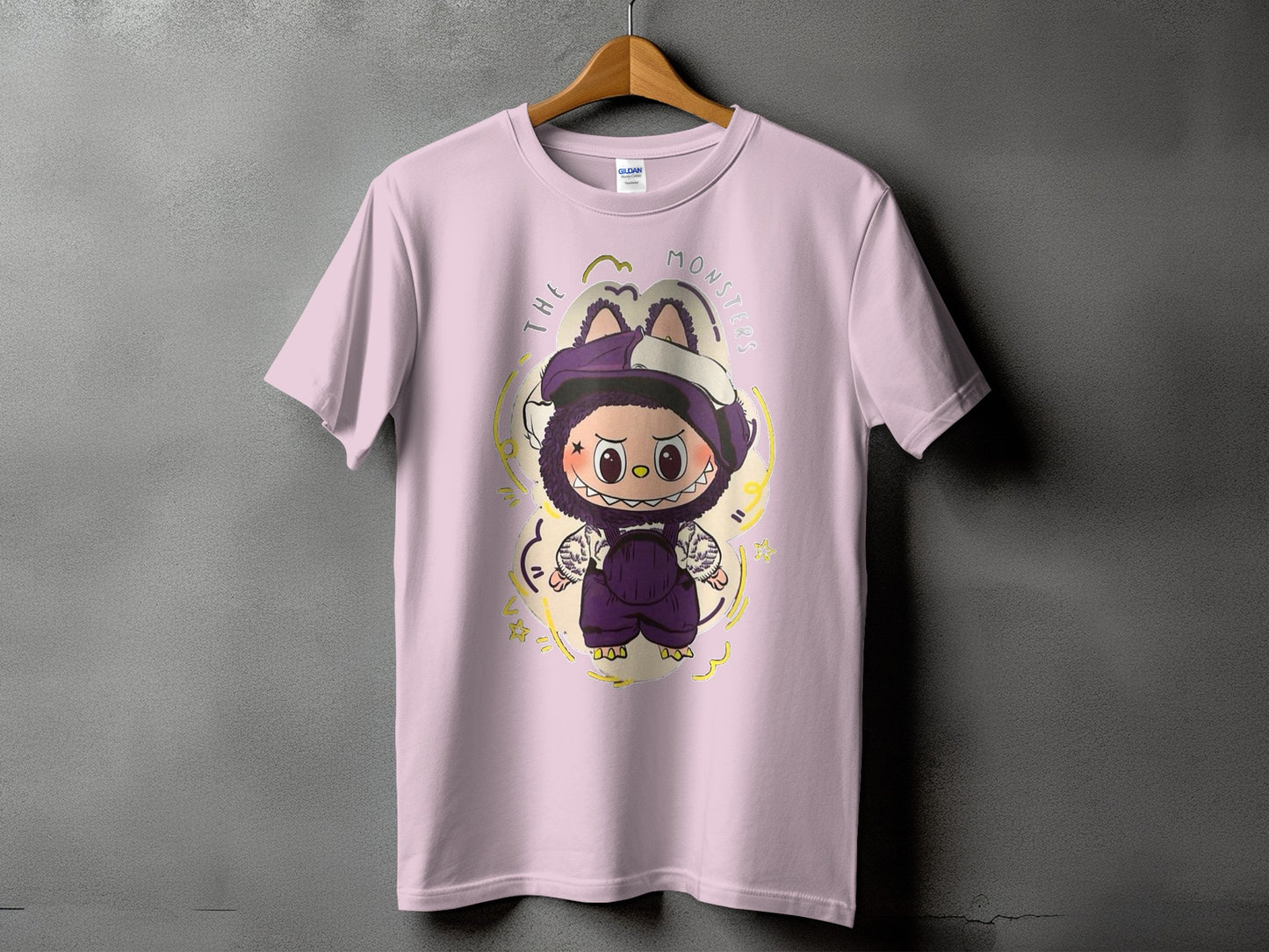Pink t-shirt with a cartoon monster graphic and text "THE MONSTERS".