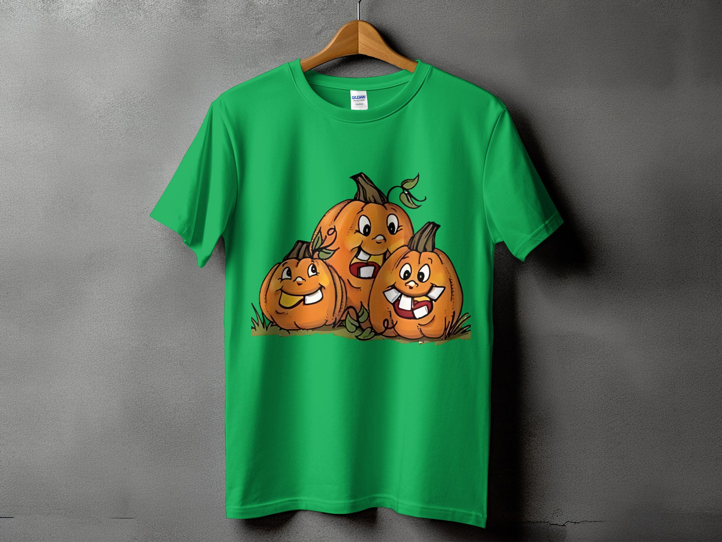 Green t-shirt with three cartoon pumpkins with happy faces.