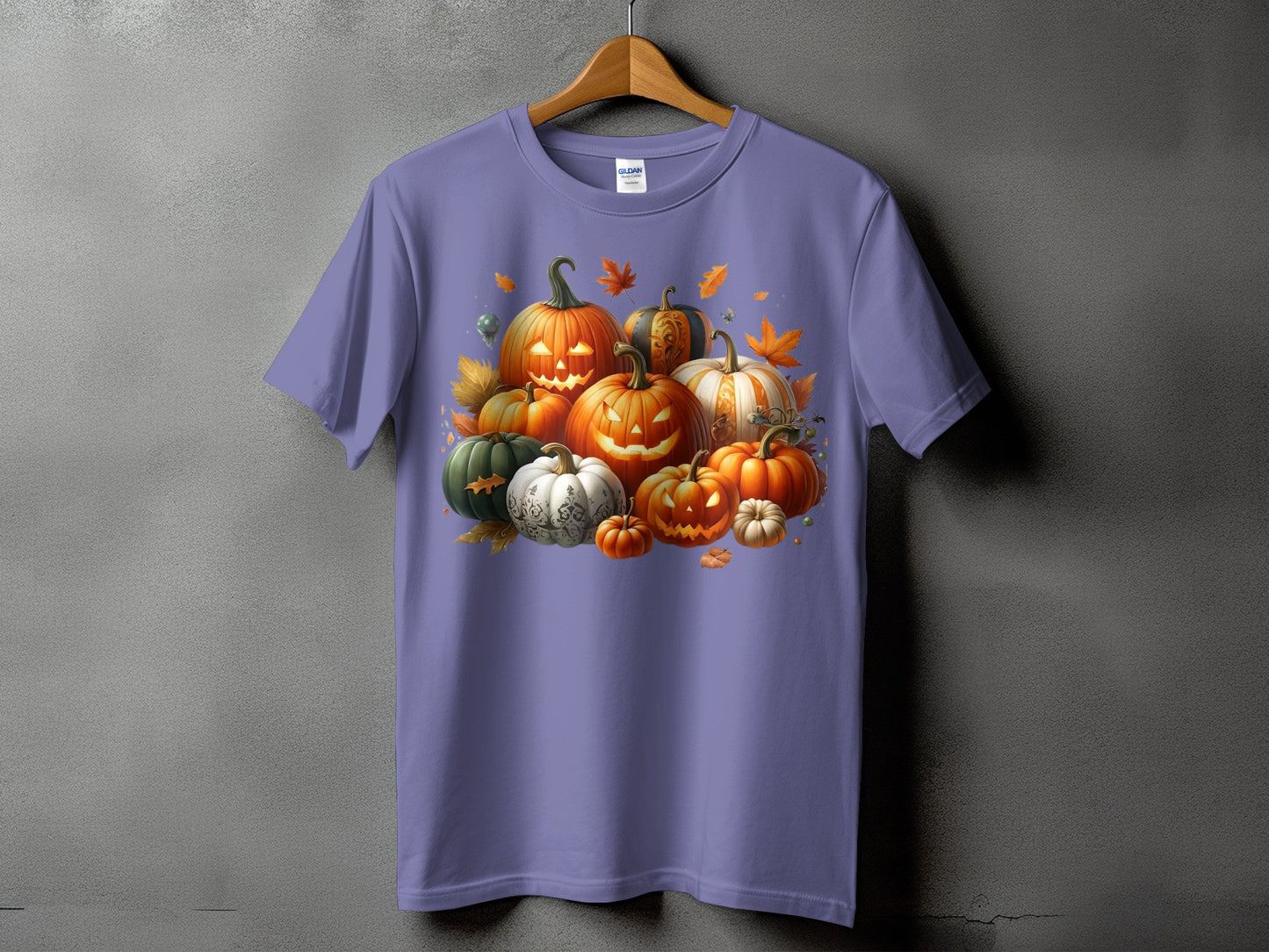 Purple t-shirt with a cluster of carved and decorative pumpkins and autumn leaves.