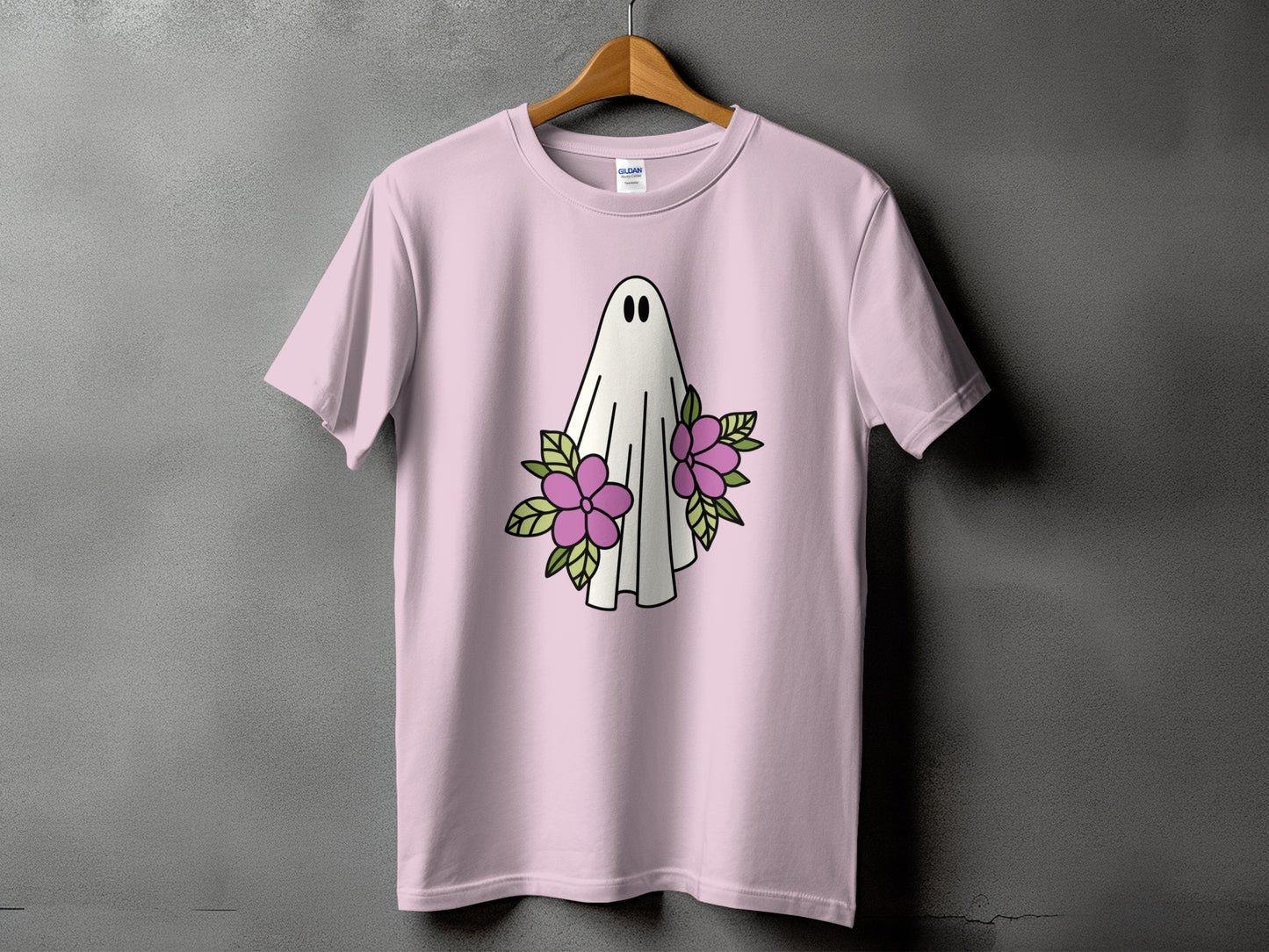 Pink t-shirt with a white ghost and purple flowers graphic.