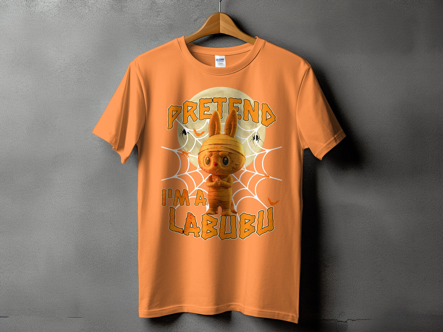 Orange t-shirt with "Pretend I'm a Labubu" text and mummy bunny graphic.