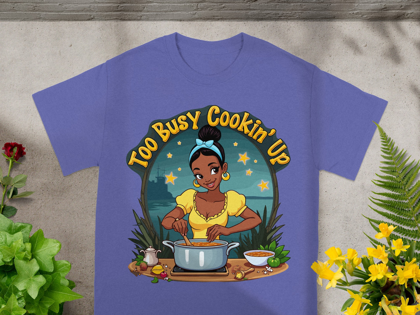 T-shirt featuring a woman cooking with "Too Busy Cookin' Up" text.