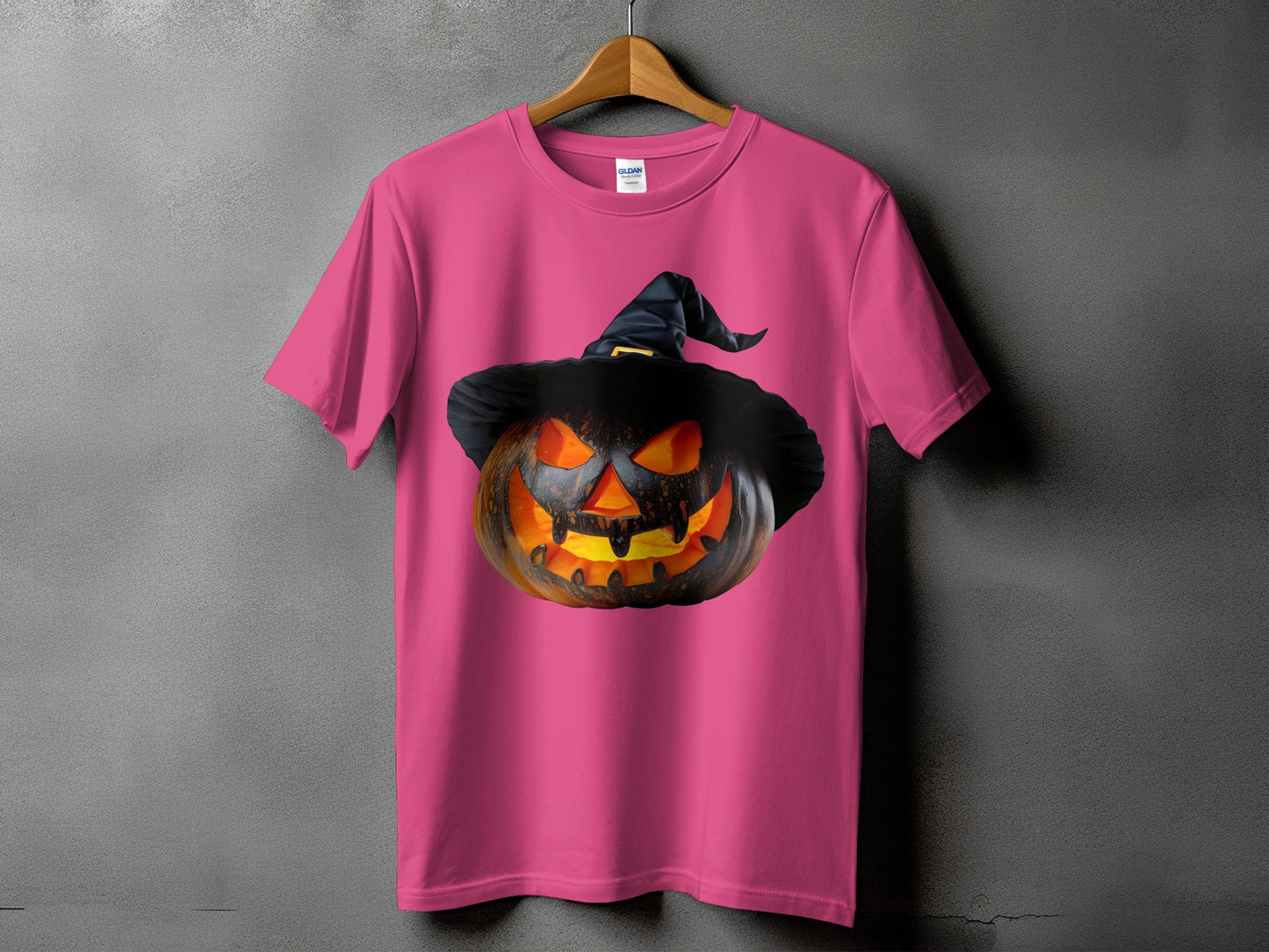 Pink t-shirt with a jack-o-lantern wearing a witch hat graphic.