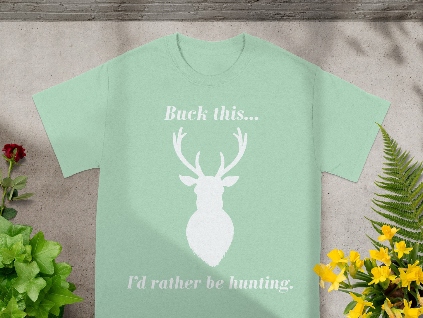 Light green t-shirt with white deer silhouette and text "Buck this..."