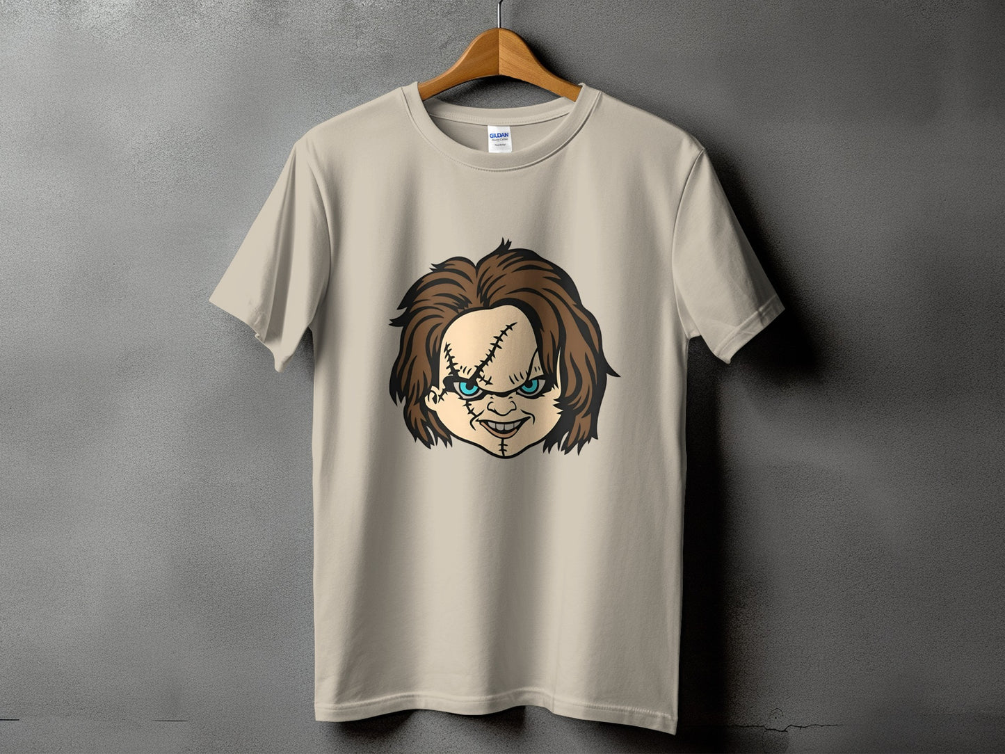 Tan t-shirt with Chucky doll head graphic on front.