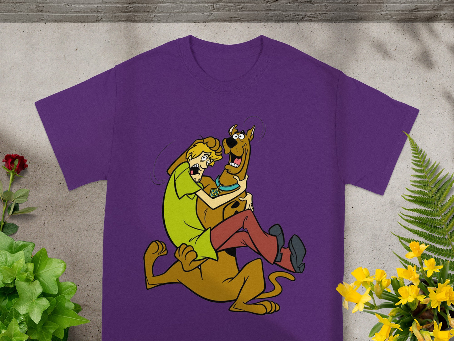 Scooby-Doo and Shaggy embracing on a purple t-shirt.