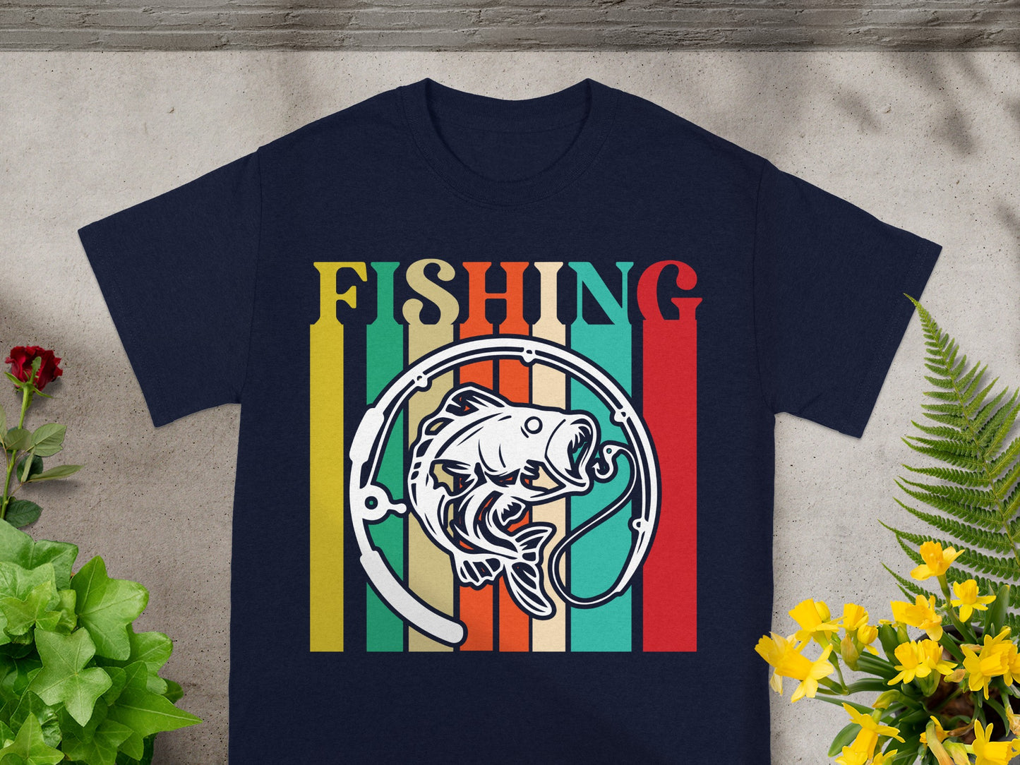 Navy t-shirt with retro "FISHING" text and a fish graphic set against colorful stripes.