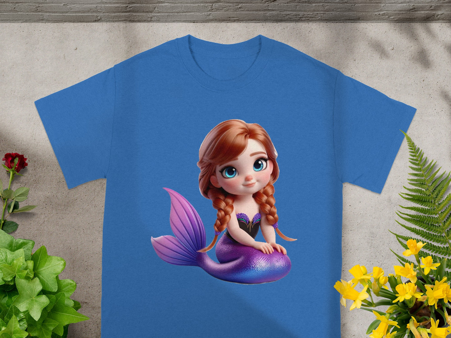 Blue t-shirt featuring a cartoon mermaid character with purple tail.