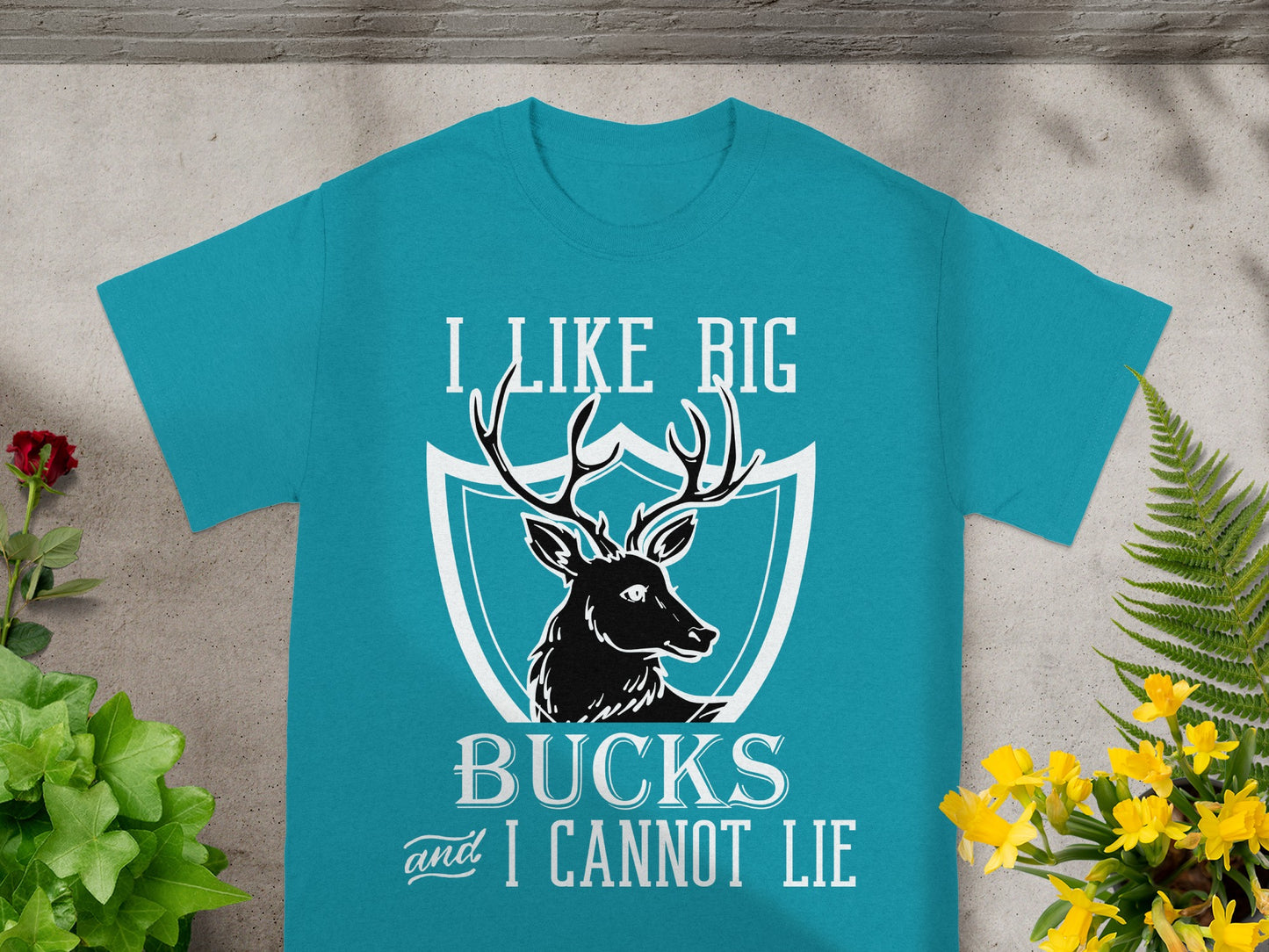 Teal t-shirt with deer graphic and text "I LIKE BIG BUCKS and I CANNOT LIE".