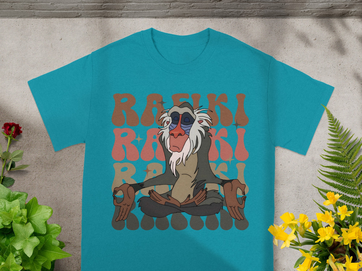 Rafiki meditating on a teal t-shirt with retro "Rafiki" text.