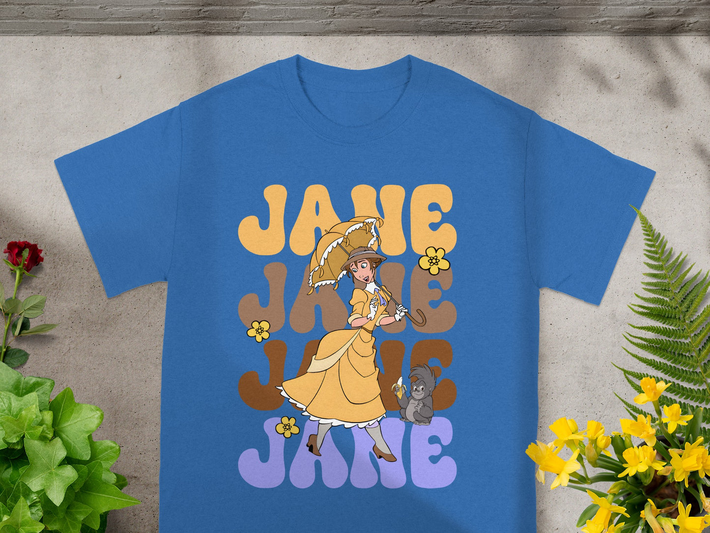 Blue t-shirt with "JANE" text and cartoon of woman with umbrella.