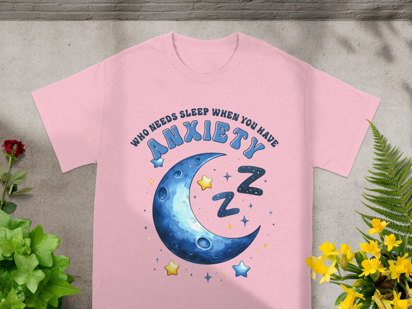 Pink t-shirt with moon, stars, and text "WHO NEEDS SLEEP WHEN YOU HAVE ANXIETY."