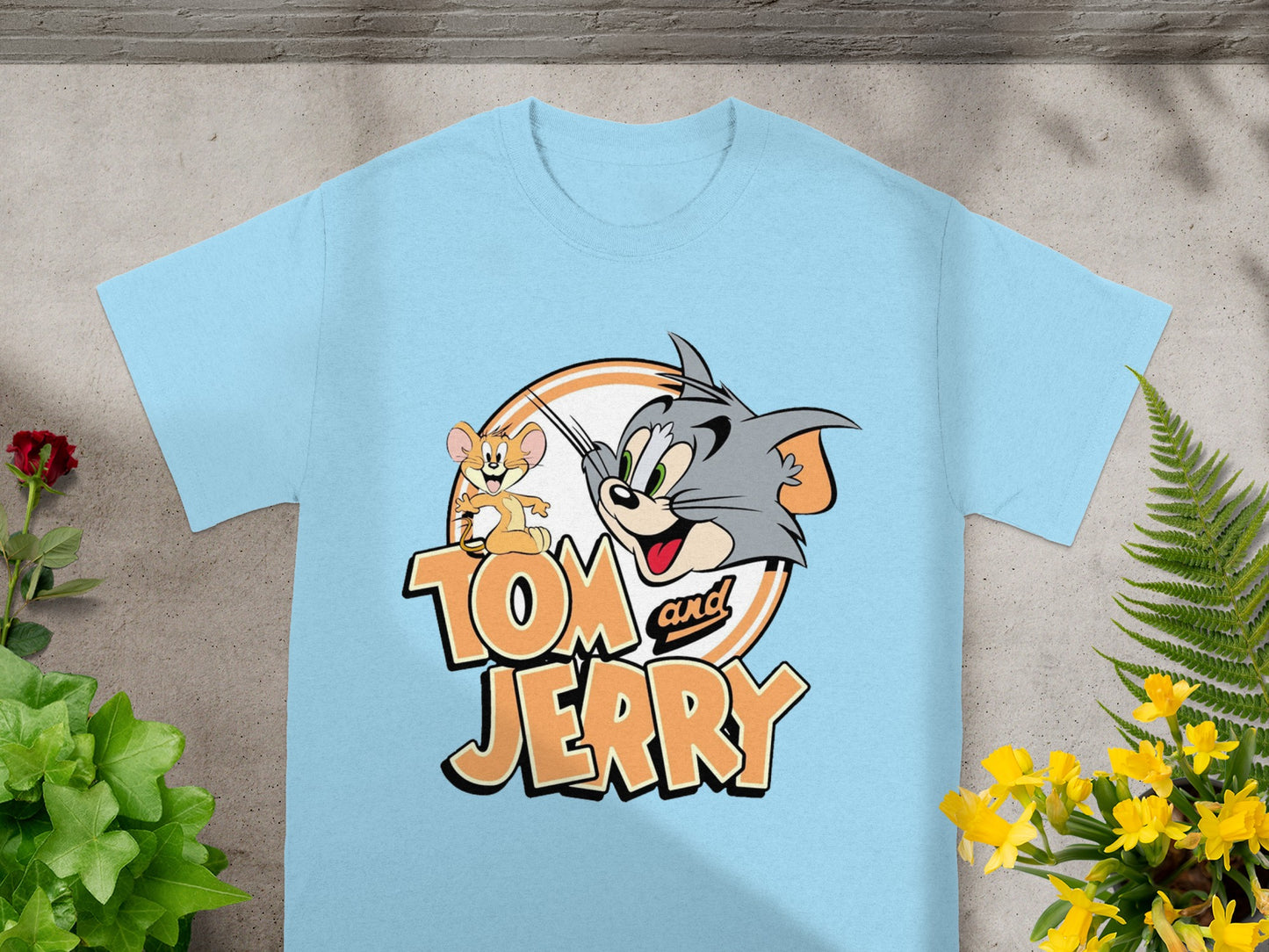 Tom and Jerry cartoon characters on a light blue t-shirt.