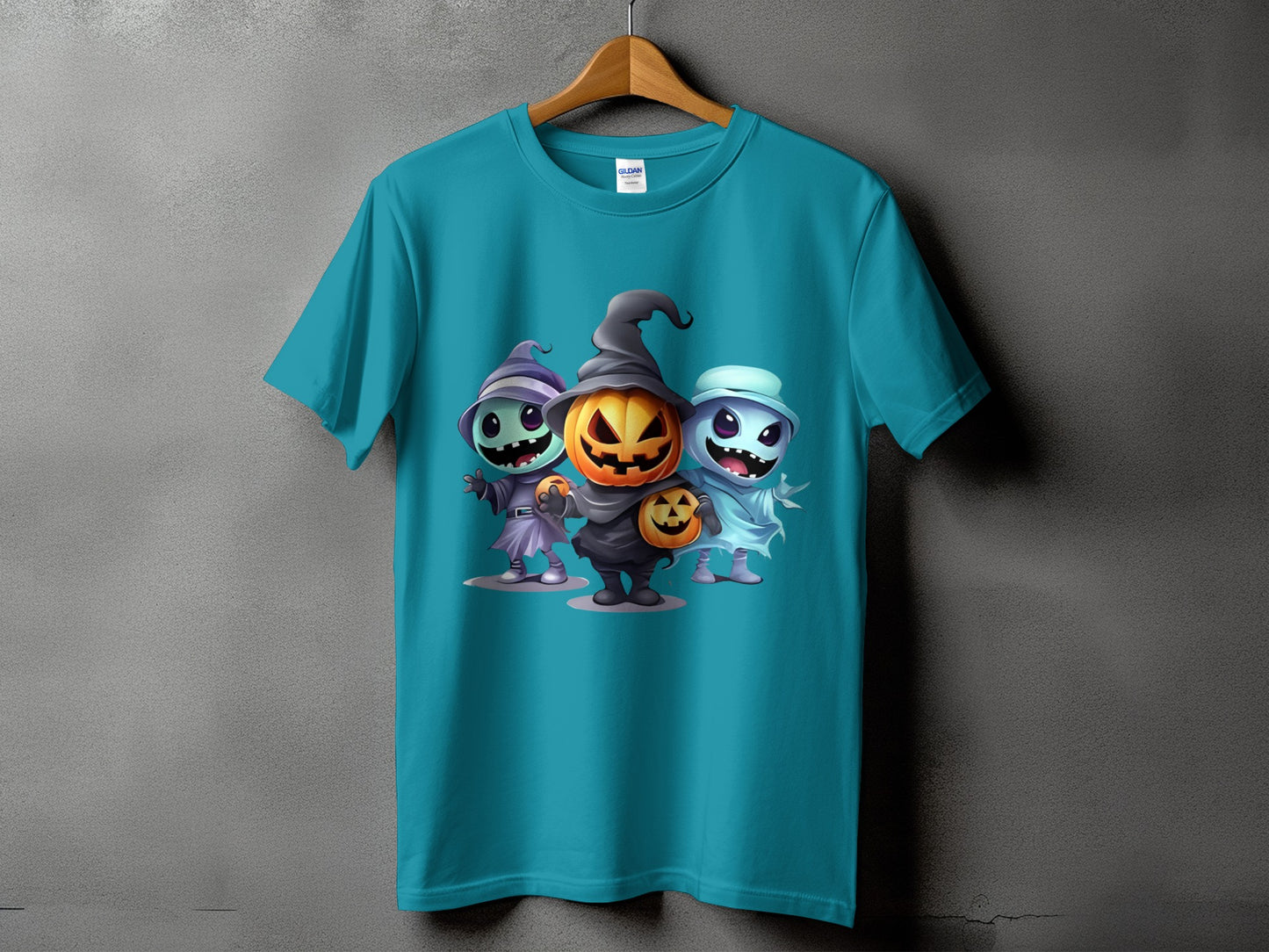 Teal t-shirt with cartoon witch, pumpkin, and ghost Halloween characters.