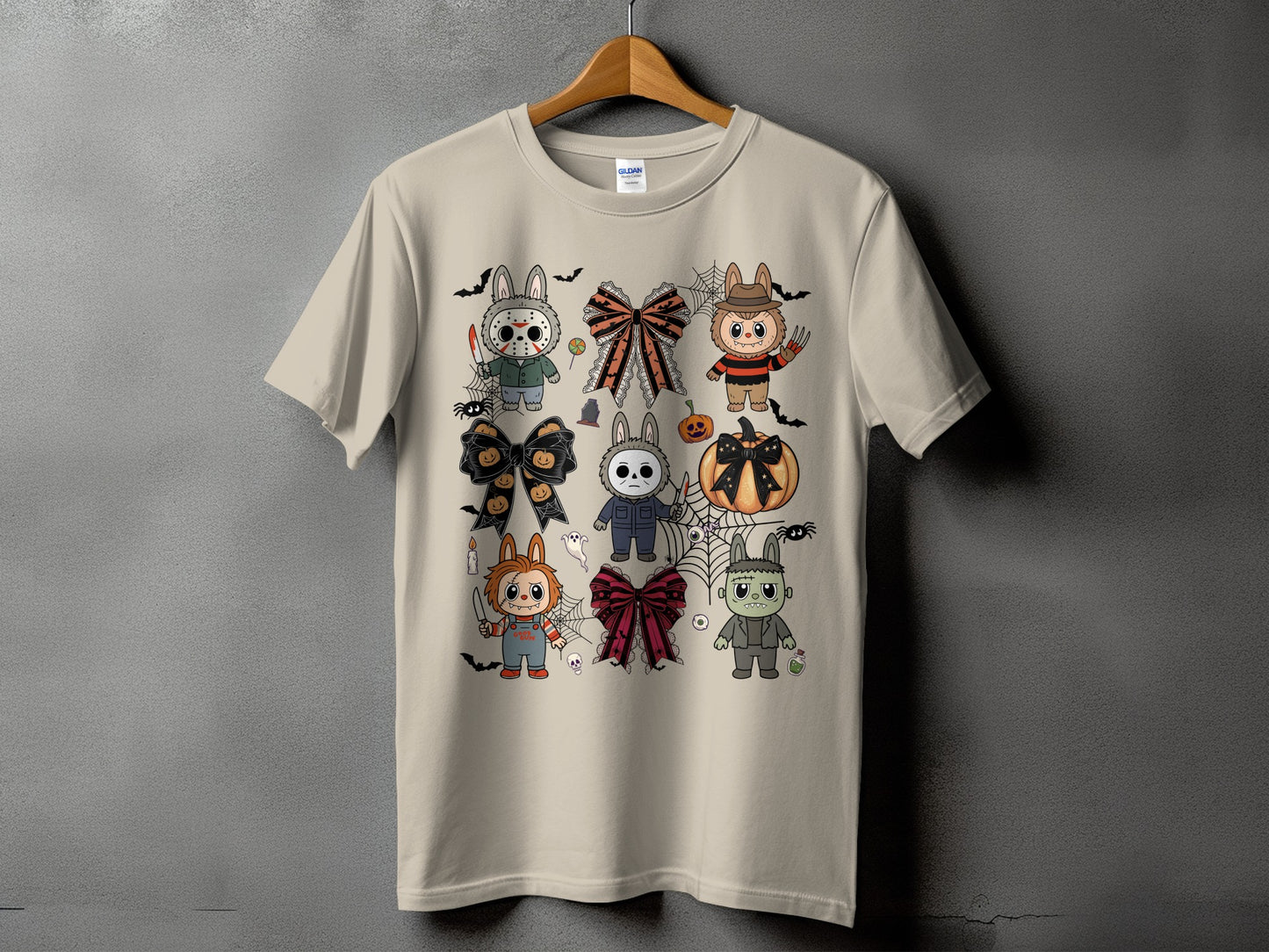 Cream t-shirt with a collage of cute Halloween characters and bows.
