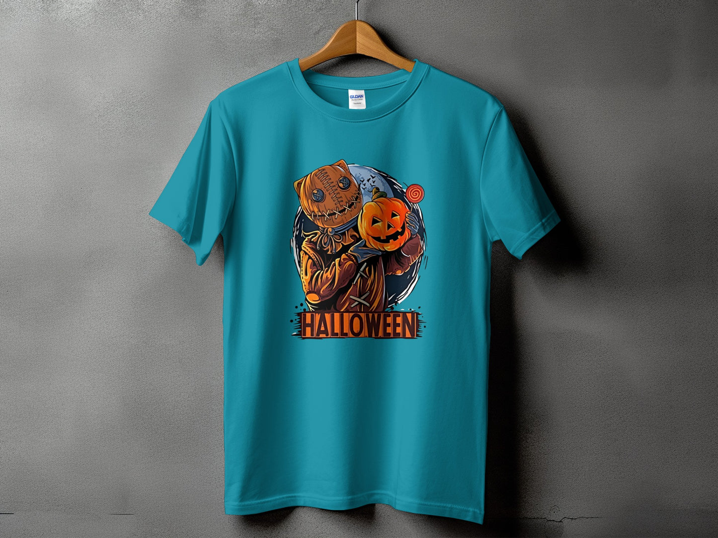 Teal t-shirt with burlap figure holding a pumpkin and candy, text reads "HALLOWEEN".