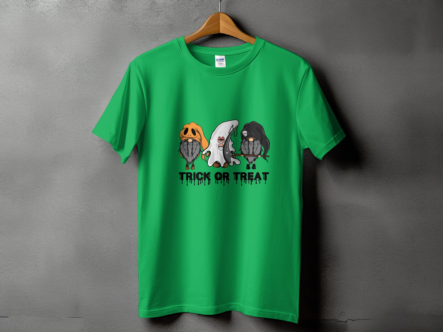 Green t-shirt with three gnomes in Halloween costumes and "Trick or Treat" text.