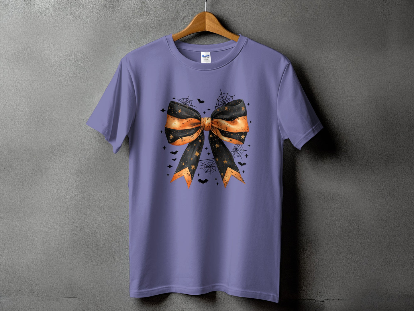 Purple t-shirt with Halloween bow, bats, cobwebs, and stars graphic.